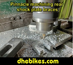 Pinnacle Innovations picture showing machining in progress of the rear shock braces for two Norco custom downhill bike's long travel rear suspension linkage plates made from 6061 aircraft aluminum.
