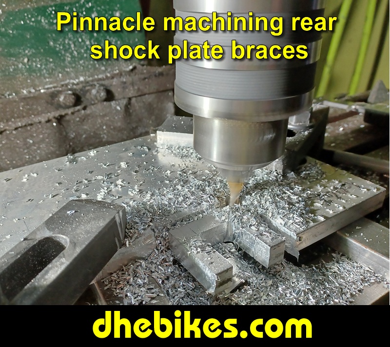 Pinnacle Innovations picture showing machining in progress of the rear shock braces for two Norco custom downhill bike's long travel rear suspension linkage plates made from 6061 aircraft aluminum.
