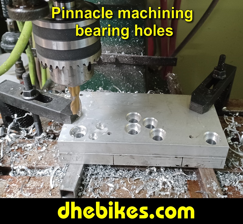 Pinnacle Innovations picture showing machining in progress of the bearing holes for two Norco custom downhill bike's long travel rear suspension linkage plates made from 6061 aircraft aluminum.
