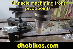 Pinnacle Innovations picture showing machining in progress of the rear pivot points for two Norco custom downhill bike's long travel rear suspension linkage plates made from 6061 aircraft aluminum.
