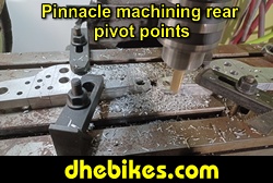 Pinnacle Innovations picture showing machining in progress of the rear pivot points for two Norco custom downhill bike's long travel rear suspension linkage plates made from 6061 aircraft aluminum.
